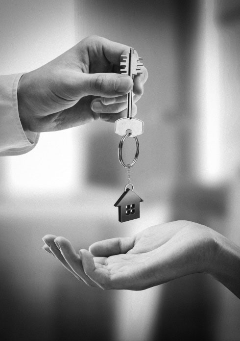 Hands holding house key